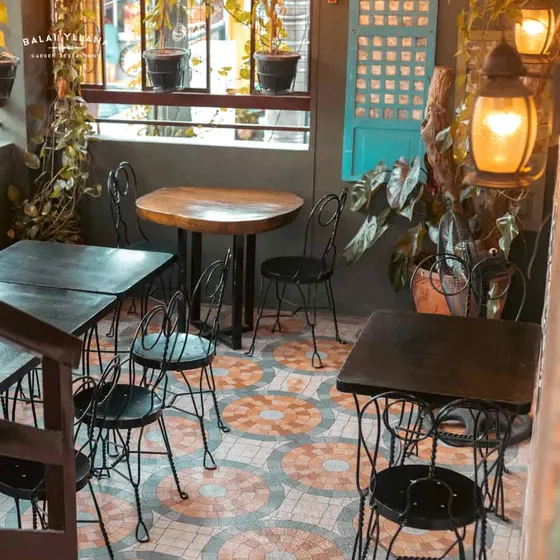 Iron chairs and small tables on the terrace, 2023